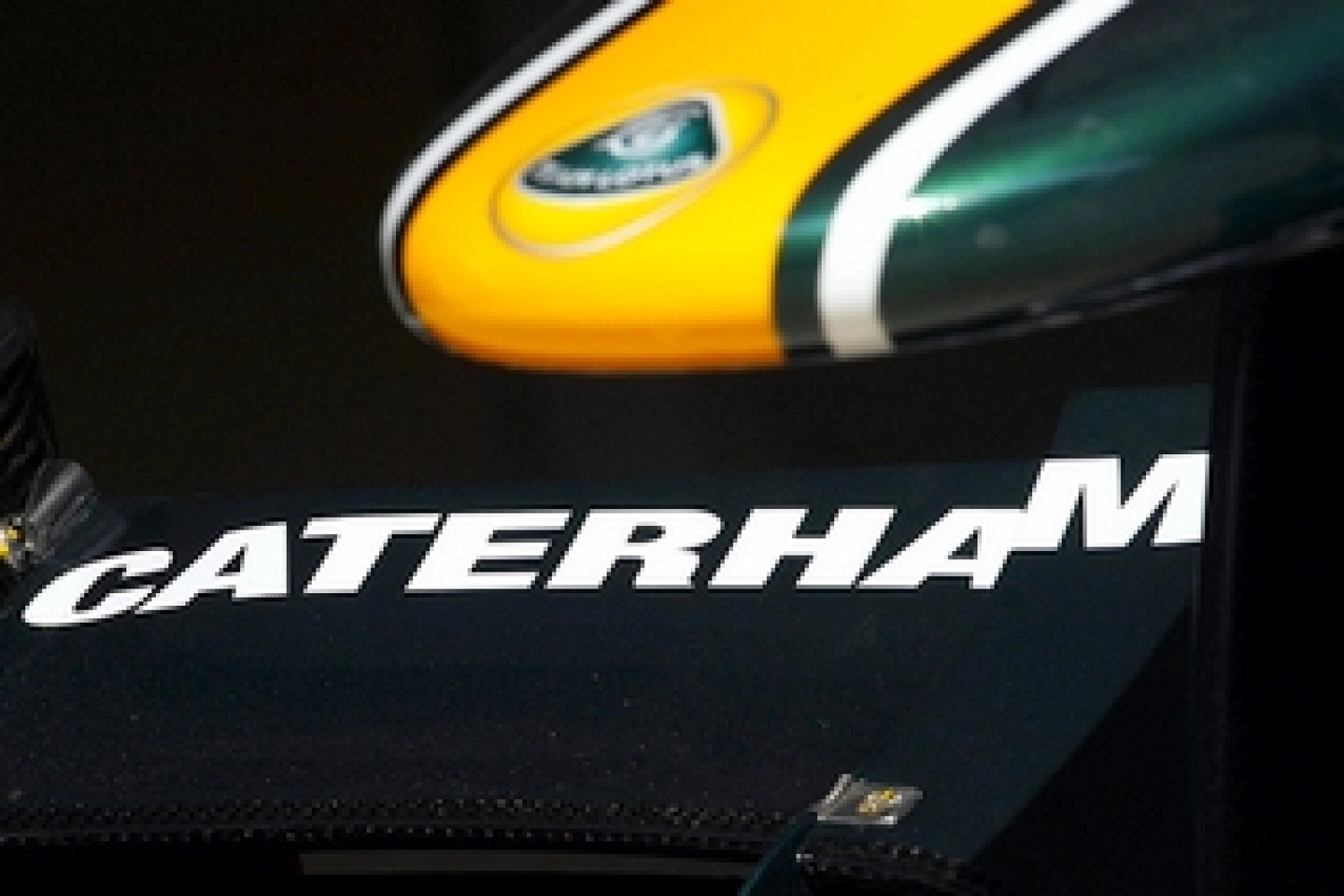 Caterham in green and yellow with Kovalainen and Trulli in 2012