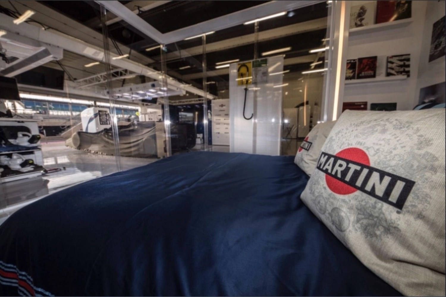 Two fans sleep in the Williams garage at Silverstone